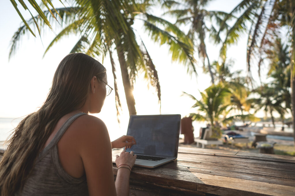 Freelancer,Girl,With,A,Computer,Among,Tropical,Palm,Trees,Work