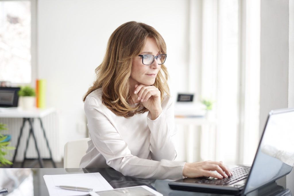 Shot,Of,An,Attractive,Mature,Businesswoman,Working,On,Laptop,In