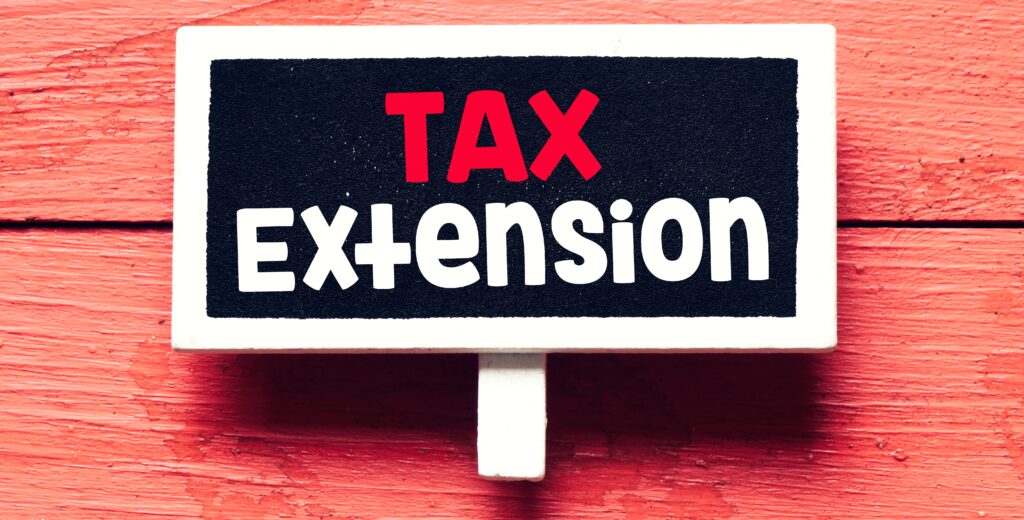 Tax,Extension,Word,On,Small,Chalkboard,And,Red,Background.,Concept